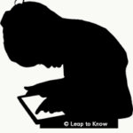 Child in silhouette working on tablet